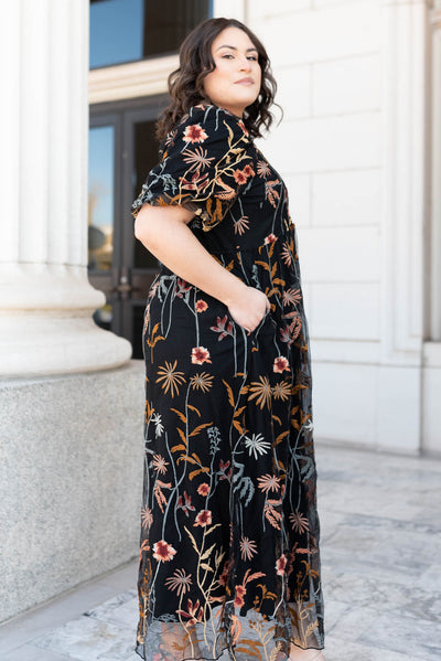 Side view of the plus size black embroidered dress