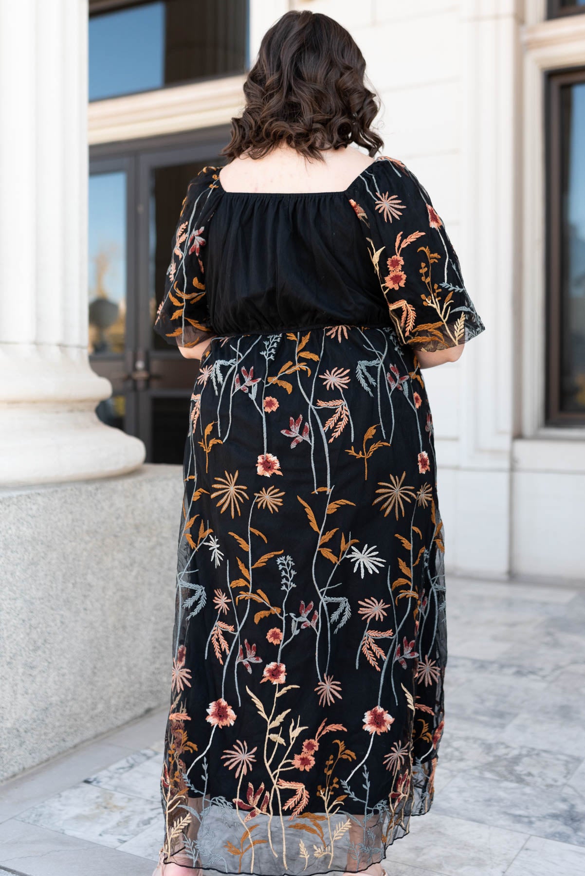 Back view of the plus size black embroidered dress