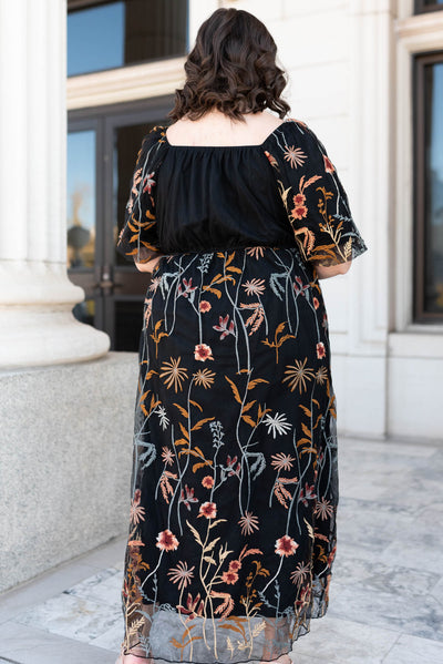 Back view of the plus size black embroidered dress