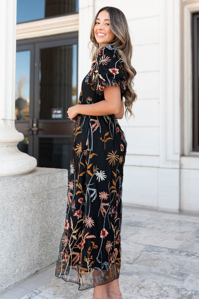 Side view of the black embroidered dress