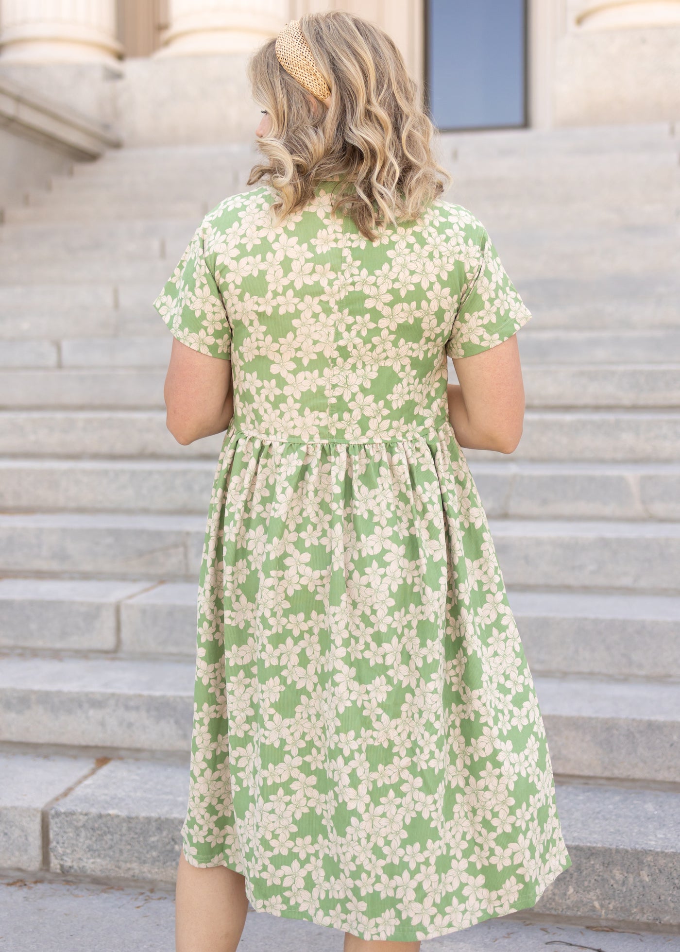 Back view of a short sleeve green floral dress