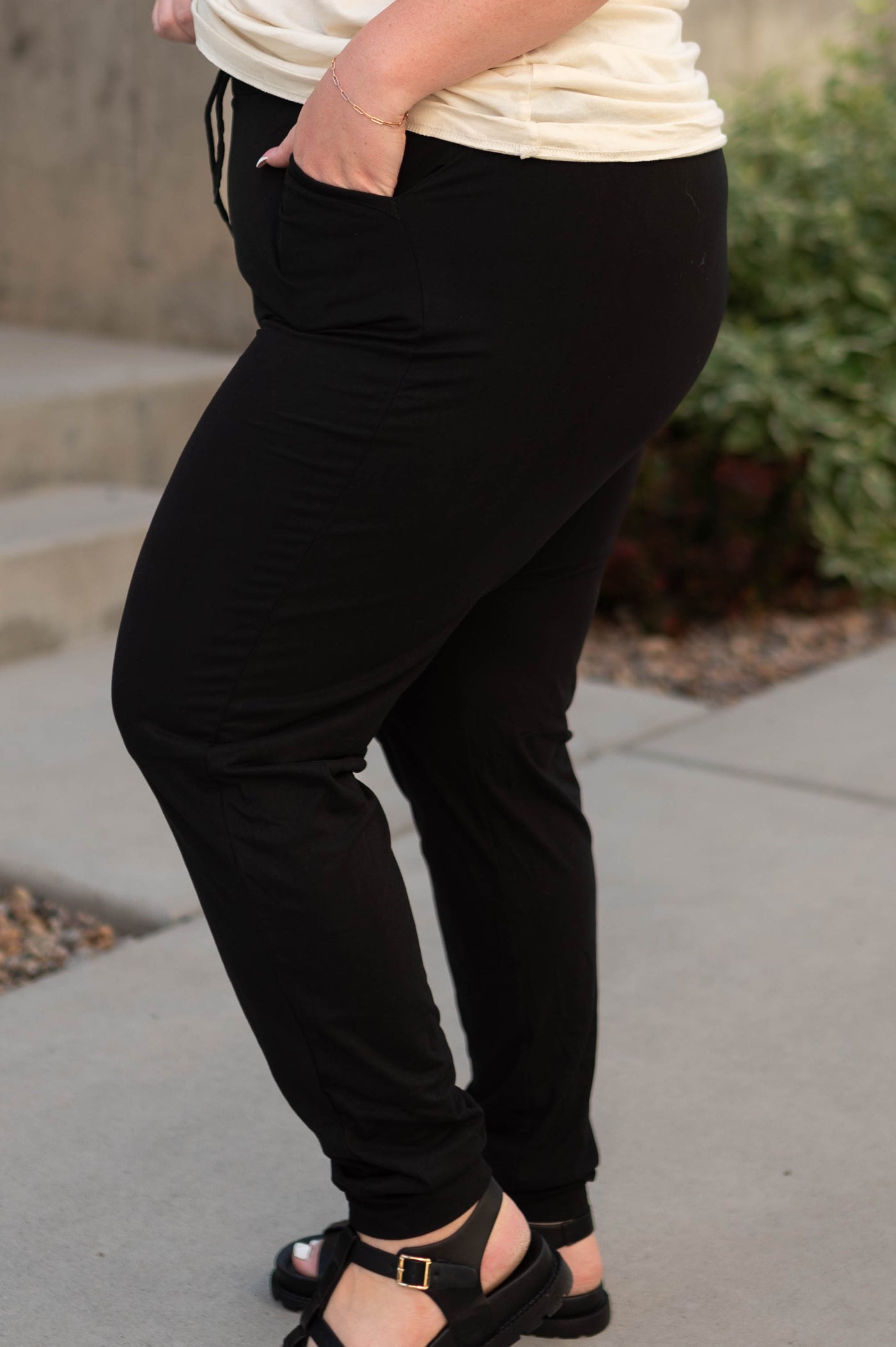 Side view of plus size knit black joggers