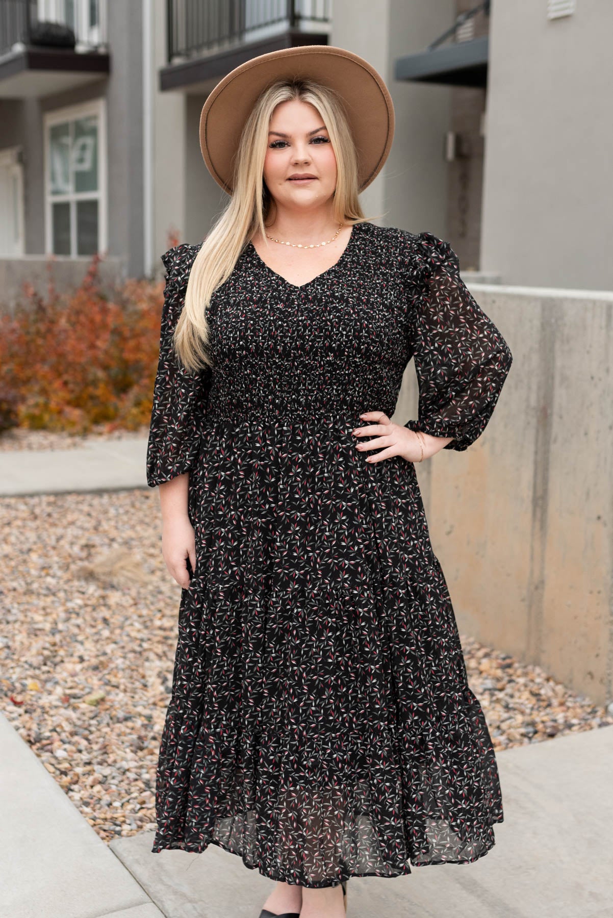 Plus size black floral dress with smocked bodice and tiered skirt