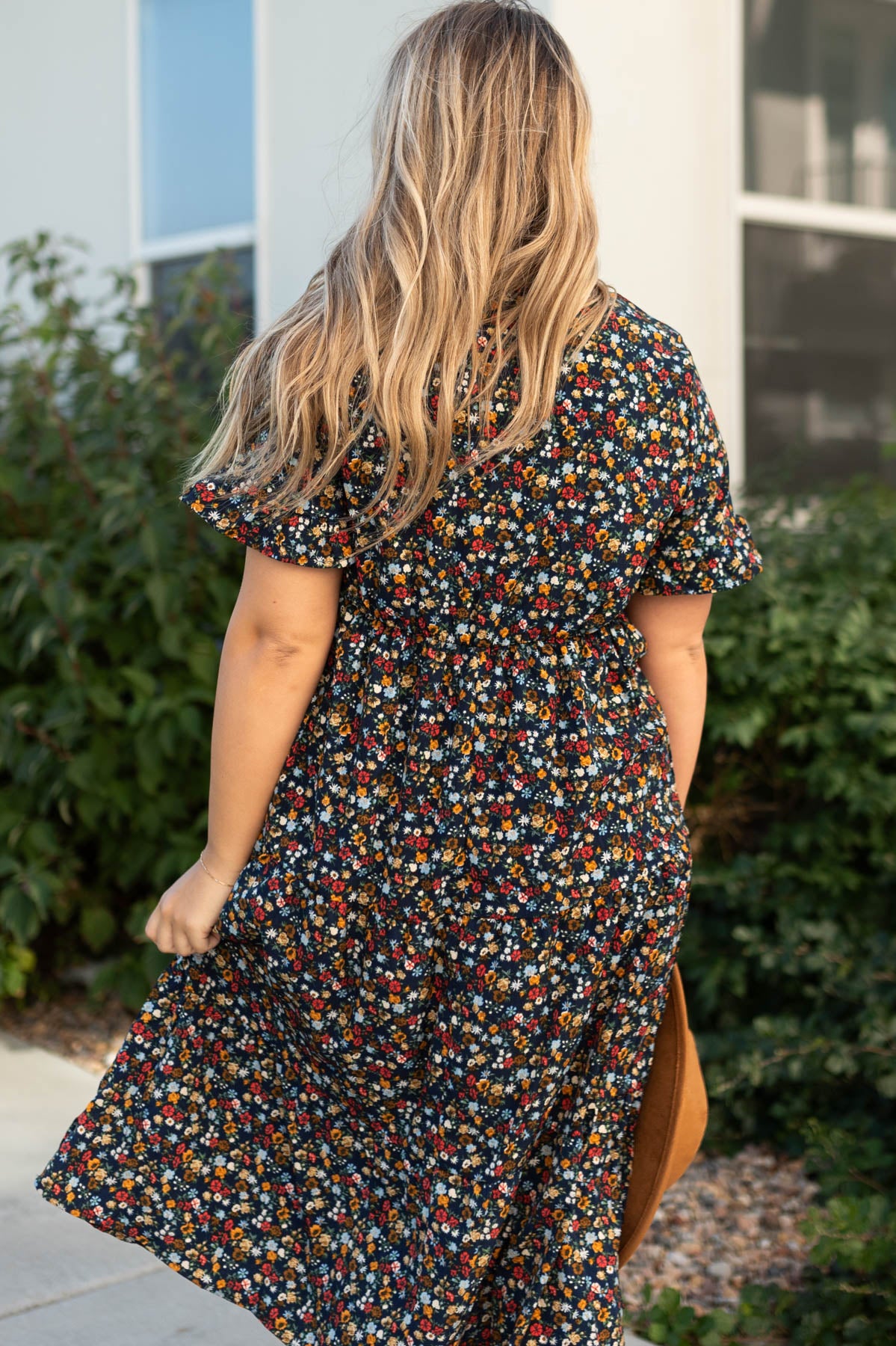 Back view of a navy floral dress