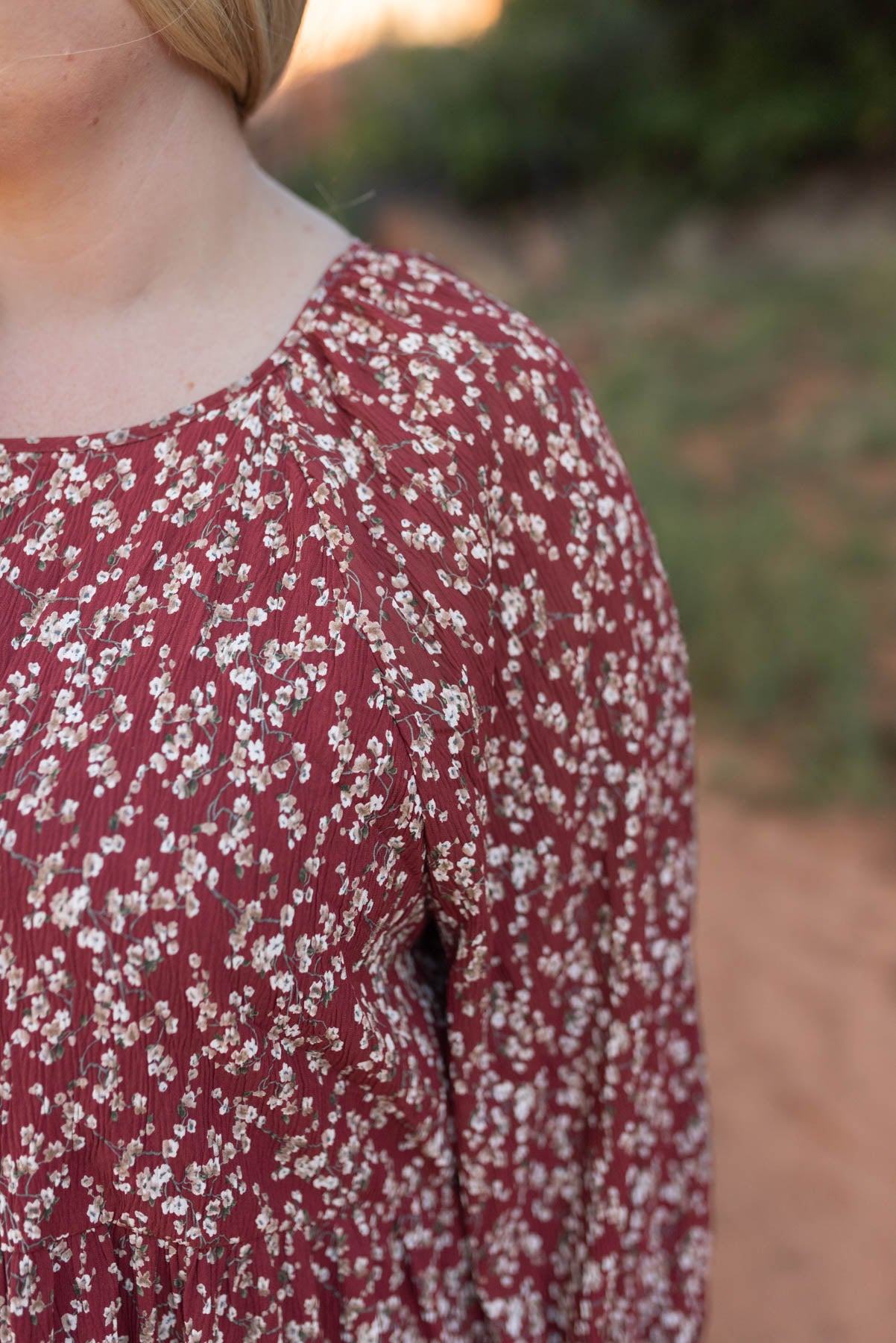 Close up of the fabric on a plus size burgundy floral dress