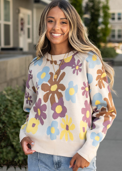 Long sleeve cream sweater with a floral print