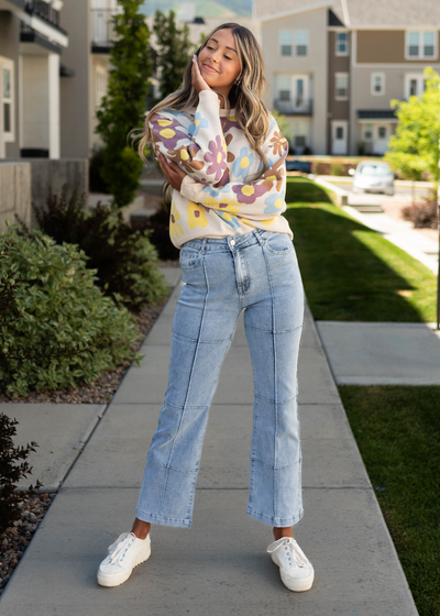 Long sleeve floral cream sweater with light denim jeans that are sold separately
