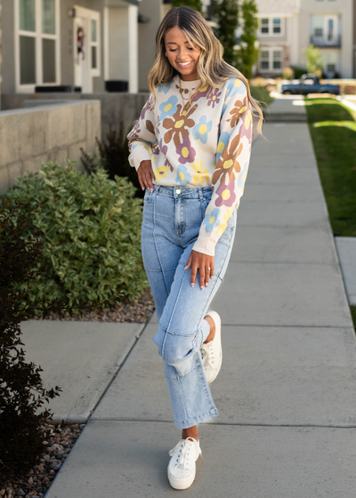Cream sweater with light denim jeans that are sold separately