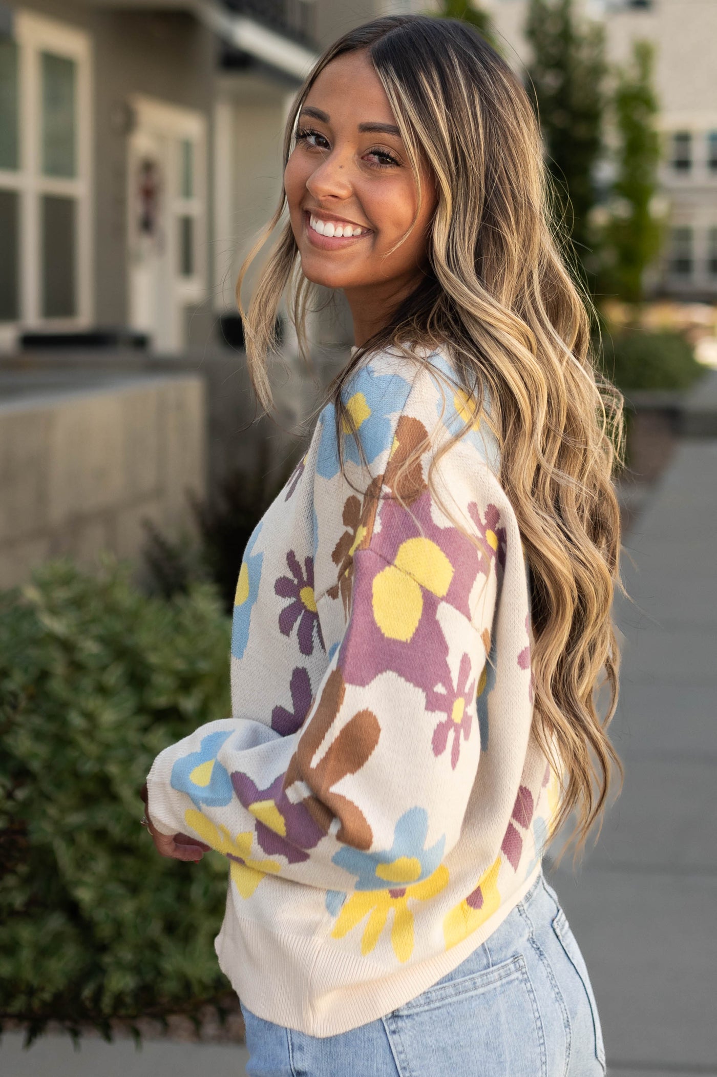 Side view of a cream sweater 