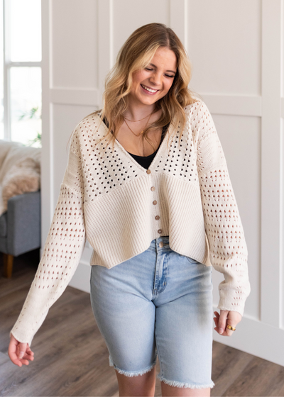 Long sleeve ivory knitted cardigan that buttons up
