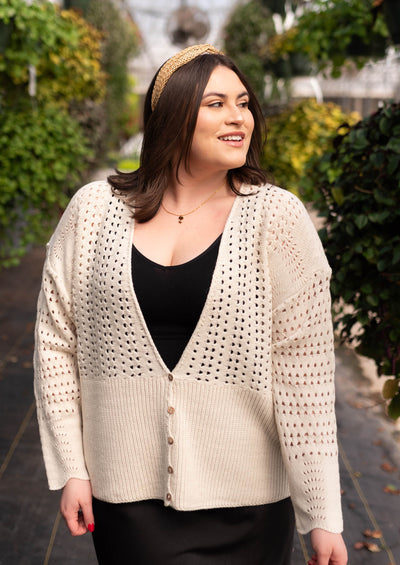 Plus size ivory knitted cardigan that buttons half way up