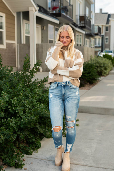 Long sleeve ivory sweater with tan checkered pattern