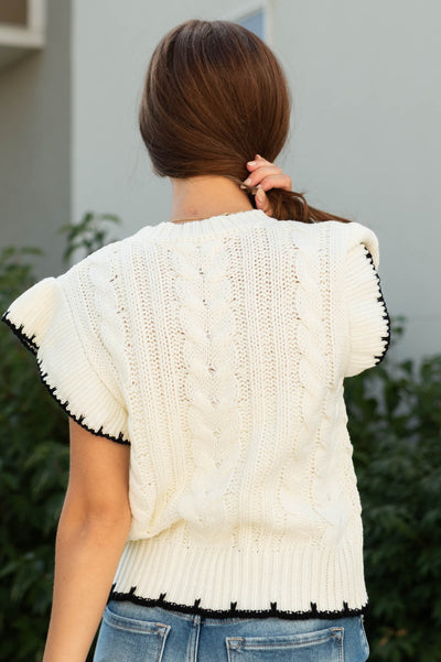 Back view of a ivory knit top
