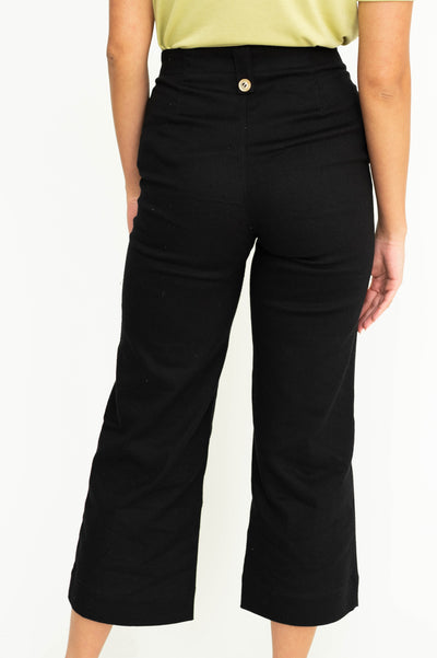 Back view of black pant with gold button.