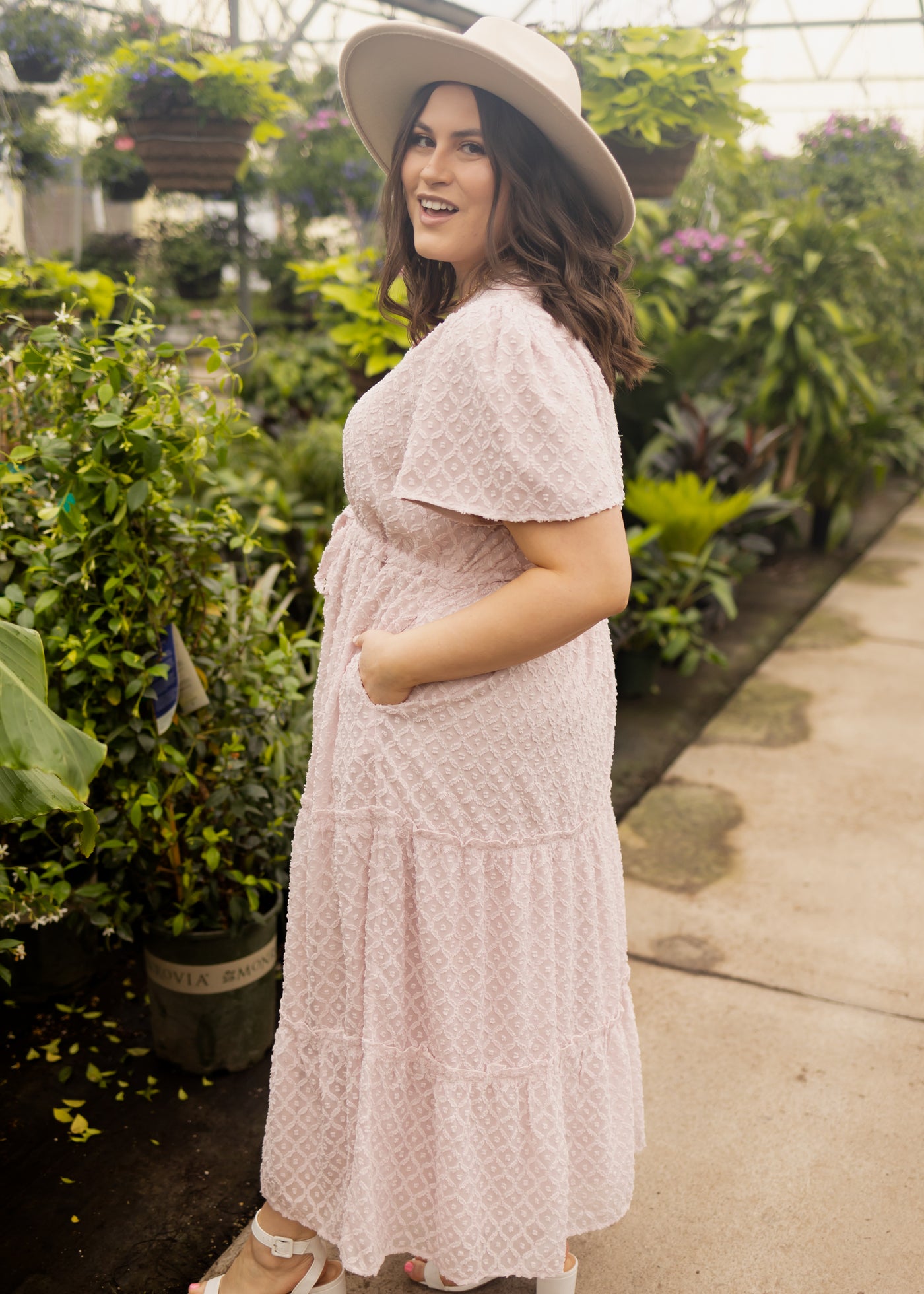 Side view of a 1x dusty pink dress with short sleeves