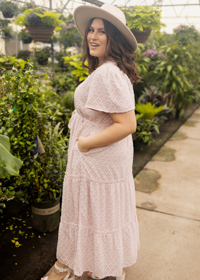 Side view of a 1x dusty pink dress with short sleeves