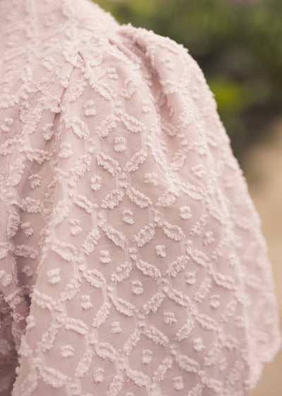 Fabric texture of a dusty pink dress