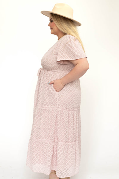 Side view of a plus size dusty pink dress