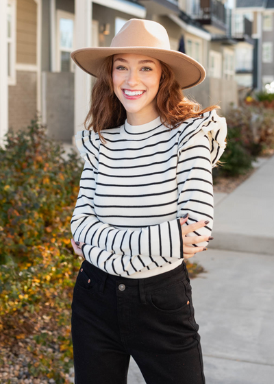 Cream stripe bodysuit with long sleeves and ruffles on the shoulders
