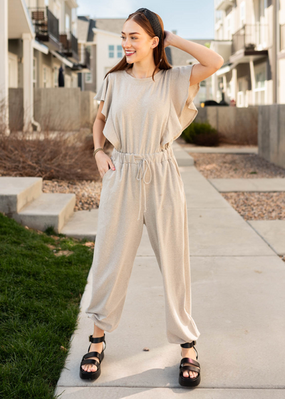 Taupe drawstring jumpsuit with tie elastic waist. 