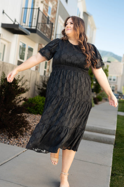 Plus size black floral dress with short sleeves and tiered skirt