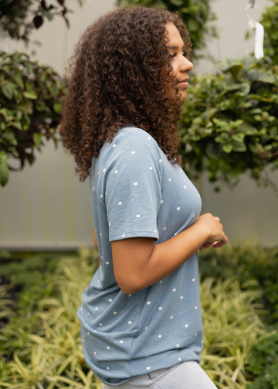 Side view of a short sleeve chambray top with white dots