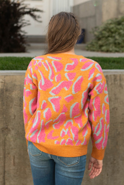Back view of a orange sweater