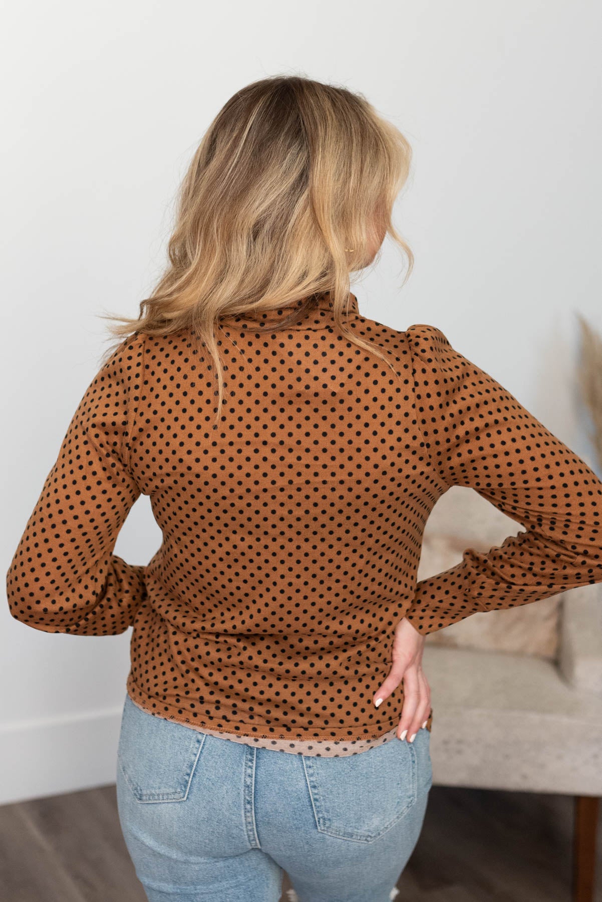 Back view of a brown turtleneck with long sleeves