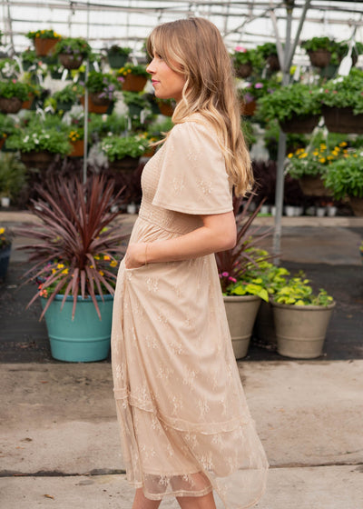 Side view of the beige smocked lace dress