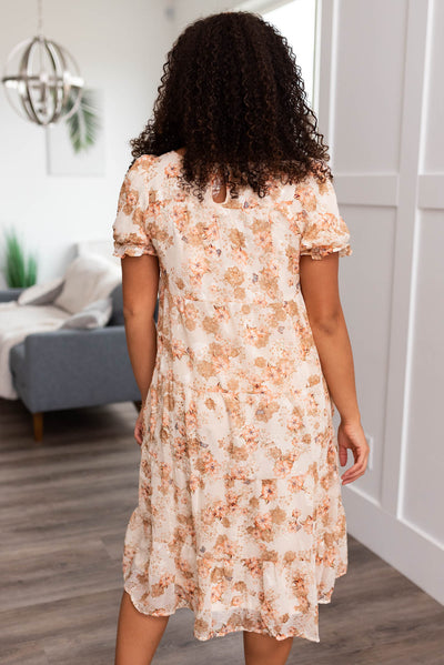 Back view of a peach floral tiered dress