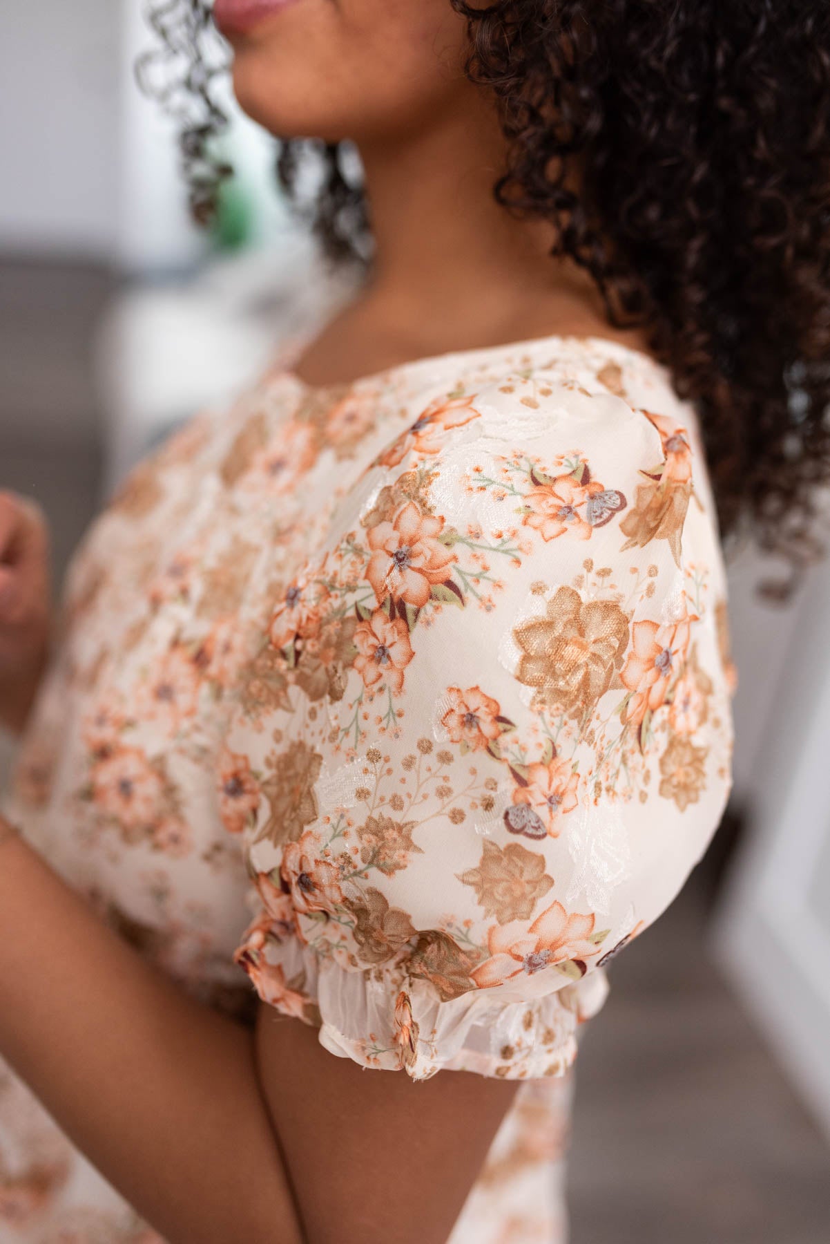 Close up of the fabric on a peach floral tiered dress