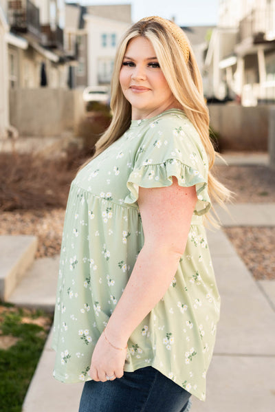 Side view of the plus size sage floral top
