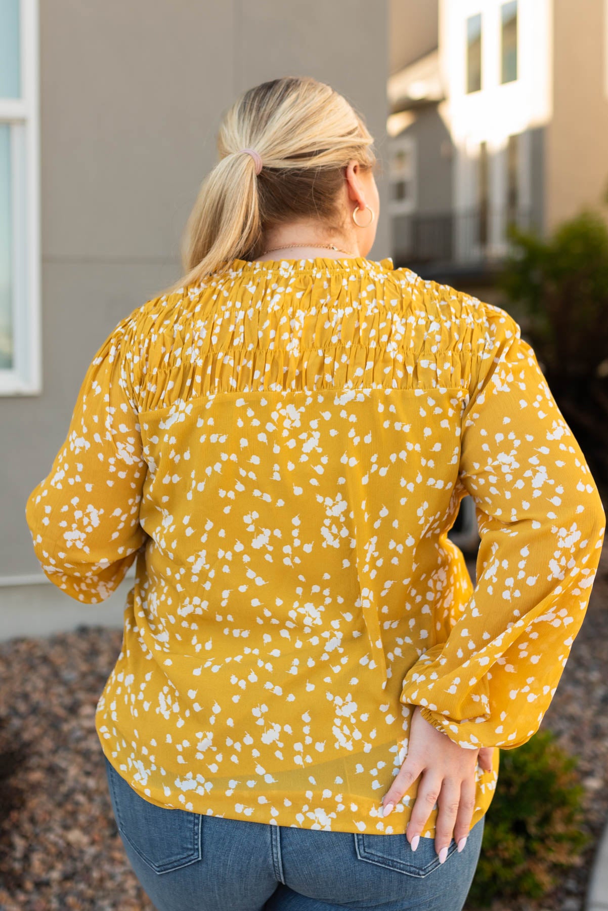 Back view of a plus size mustard ruffle blouse