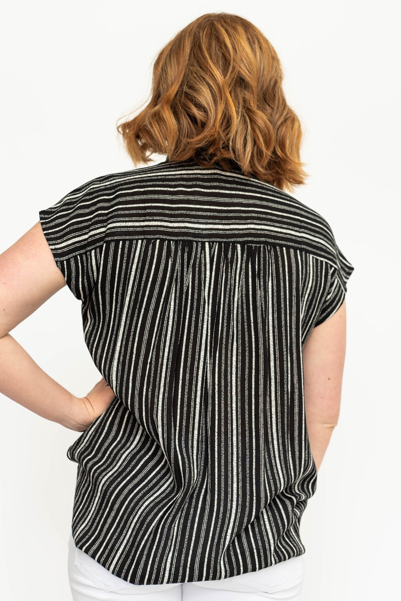 Back view of a button up black top