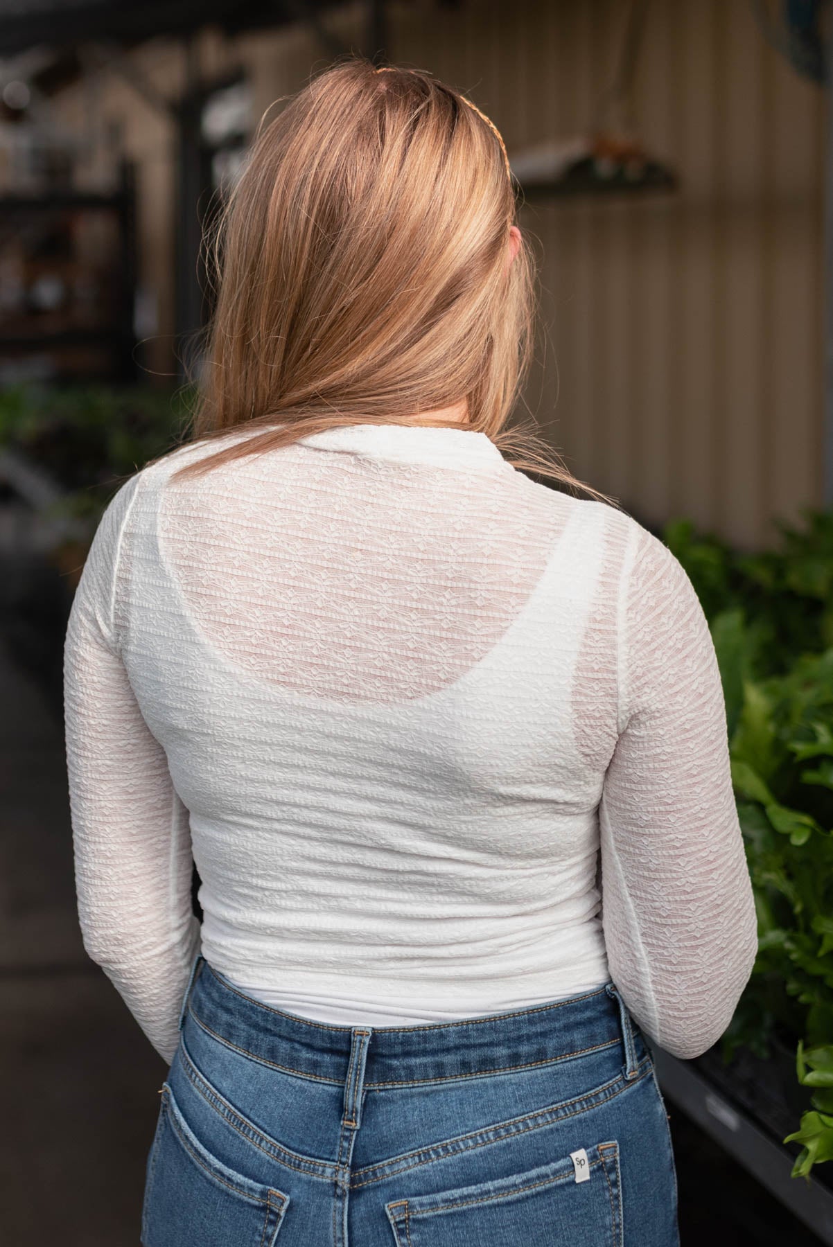 Back view of the white floral stretch lace top