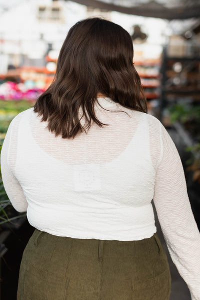 Back view of the plus size white floral stretch lace top