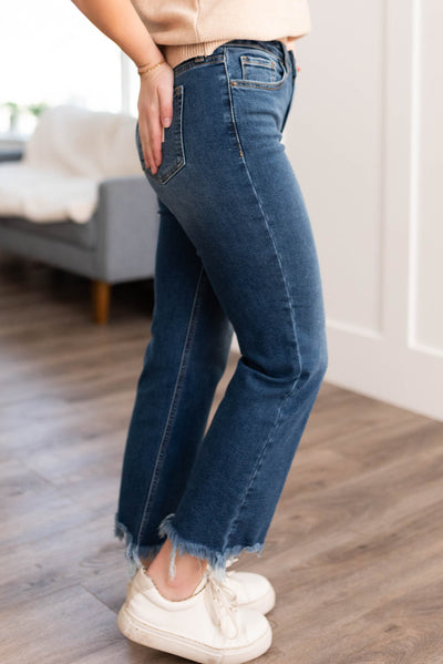 Side view of medium dark jeans with frayed hem