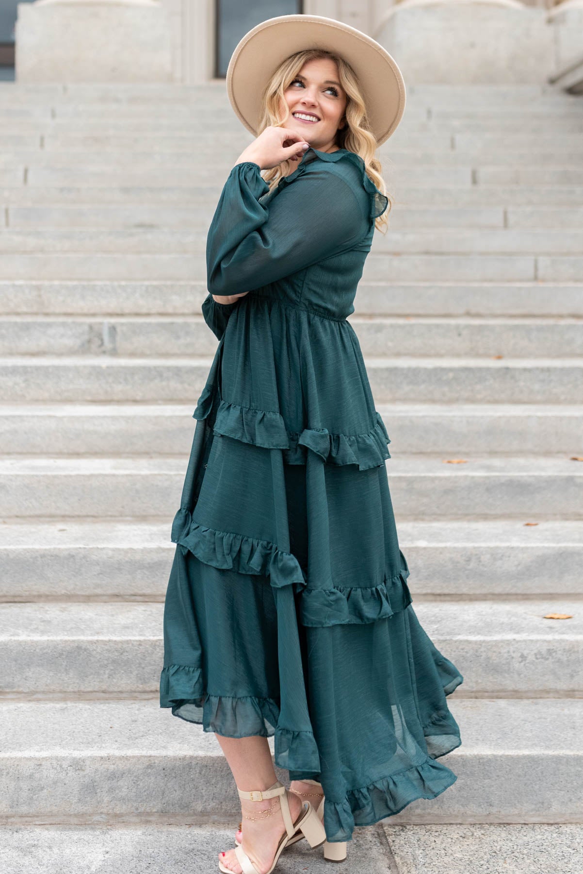 Side view of a long sleeve hunter green tiered dress