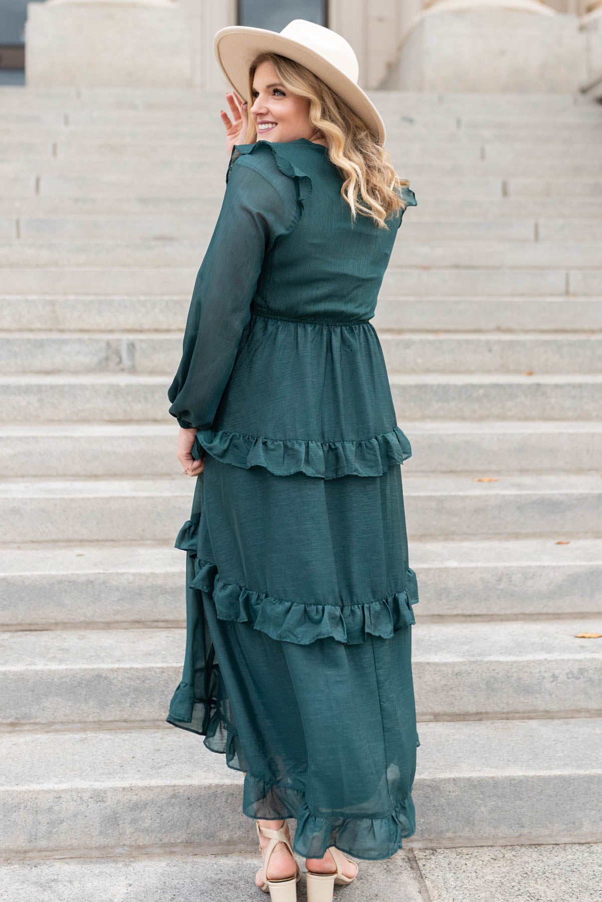 Side view of a hunter green tiered dress