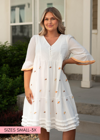 Short sleeve white dress with fringe at the bottom of the skirt