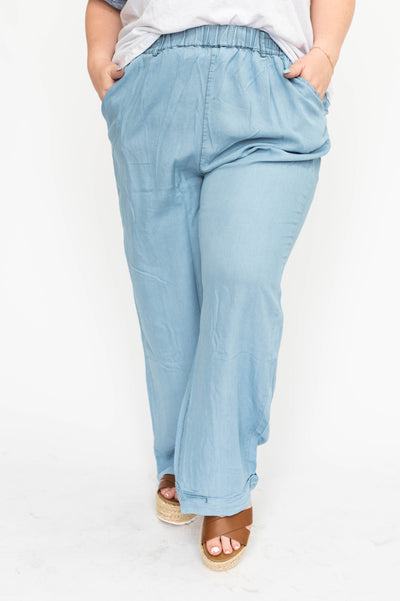Front view of plus size light denim pants