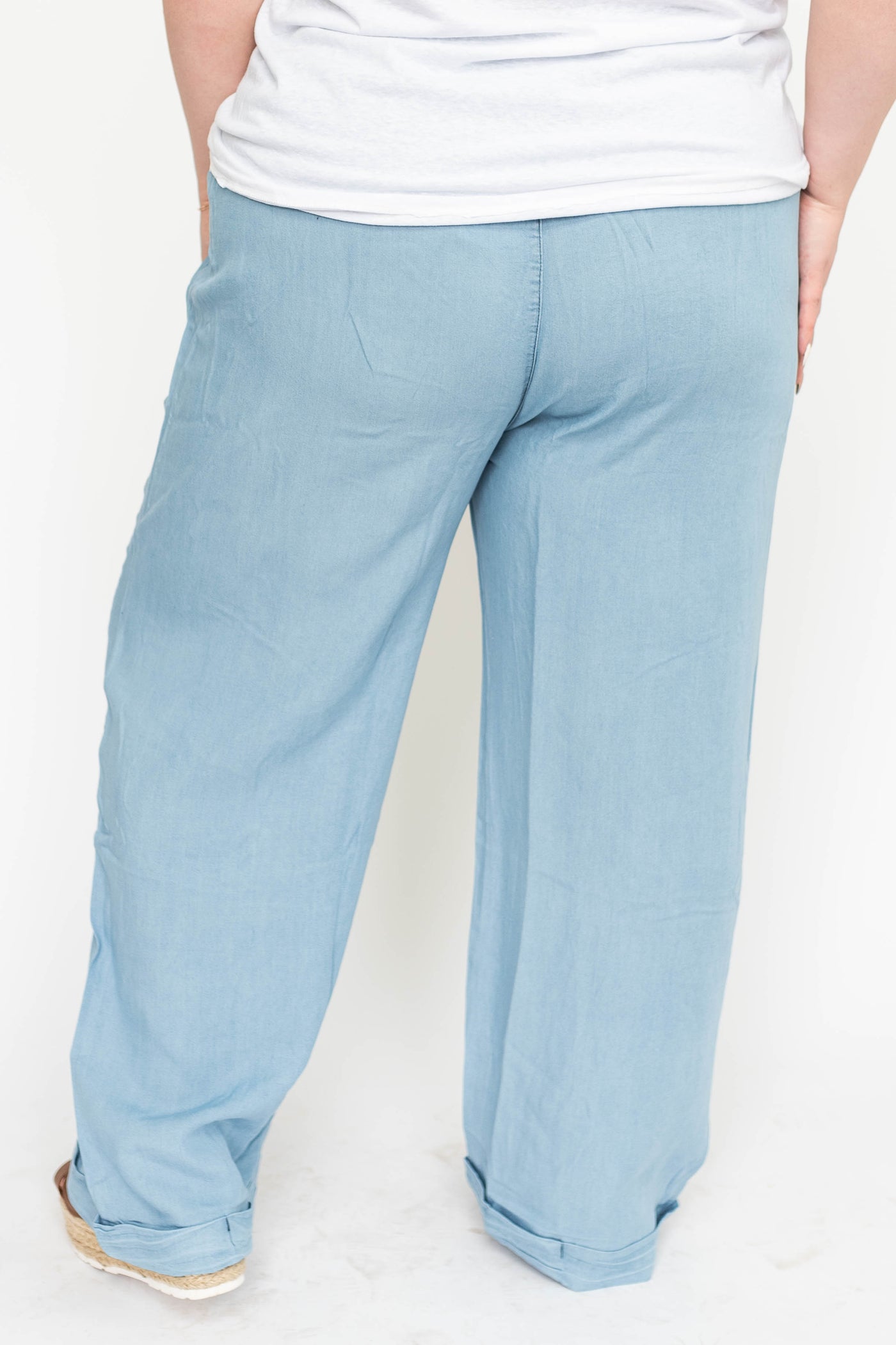 Back view of plus size light denim pants