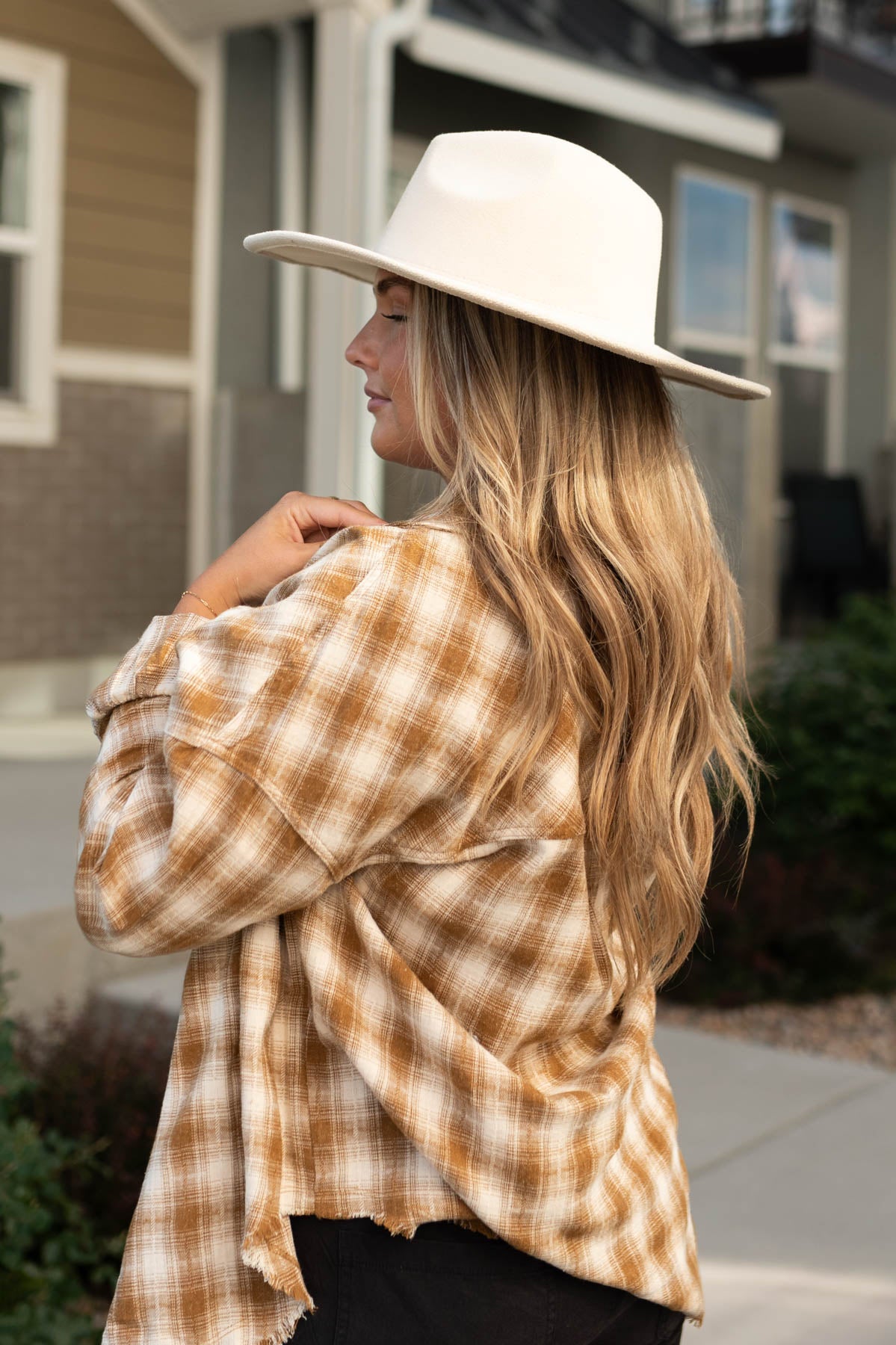 Side view of a caramel plaid top