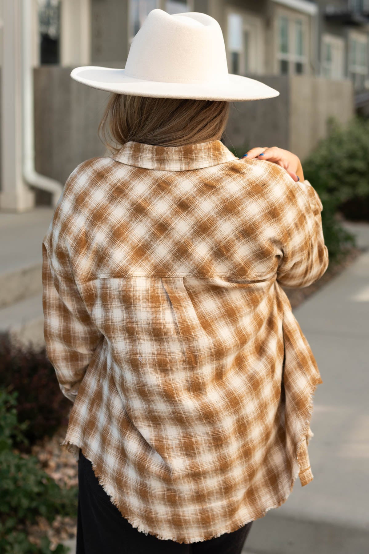 Back view of a caramel plaid top