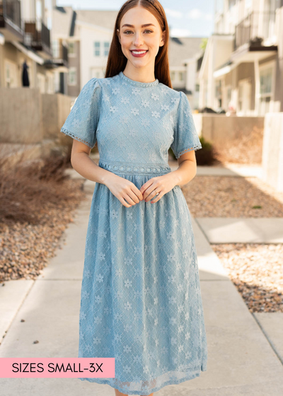 Dusty blue corded lace dress with lace detail around the waist.