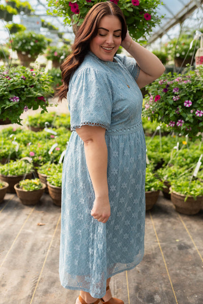 Side view of the plus size dusty blue corded lace dress