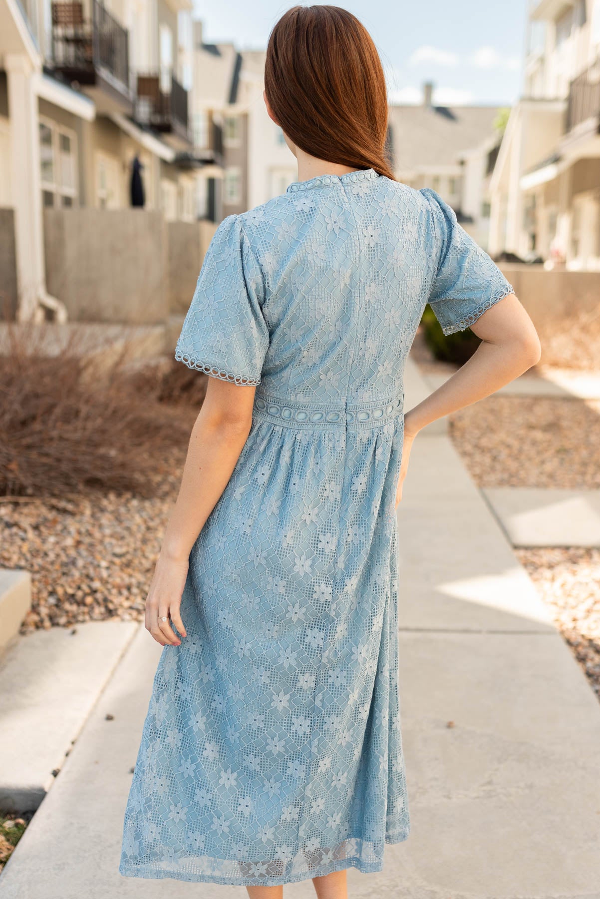 Back view of the dusty blue corded lace dress