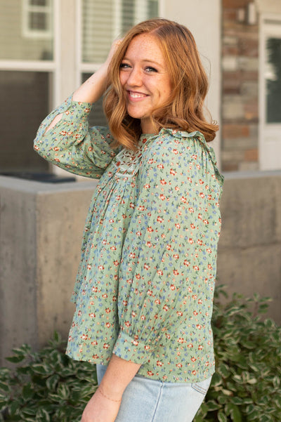 Side view of a sage floral top