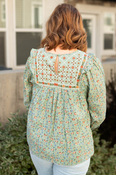 Back view of a sage floral top