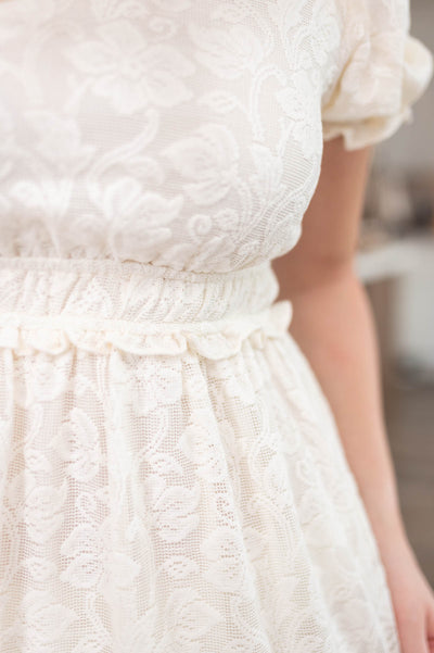 Close up of the fabric on the off white ruffle lace dress
